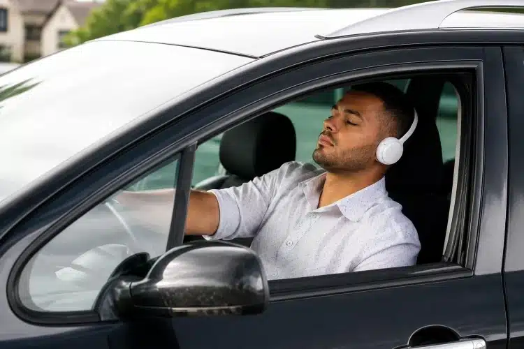 man wearing headphones while driving